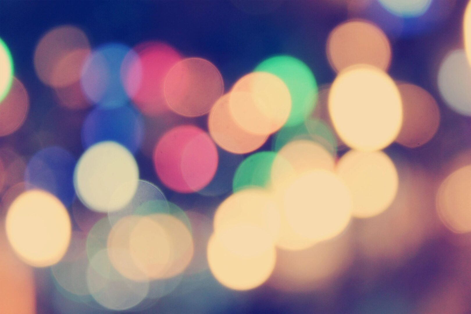 Soft-focus photograph of colorful bokeh lights.