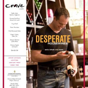 Man pouring a bottle of wine with a joyful expression in a well-stocked wine cellar, capturing the essence of indulgence for our next print campaign.